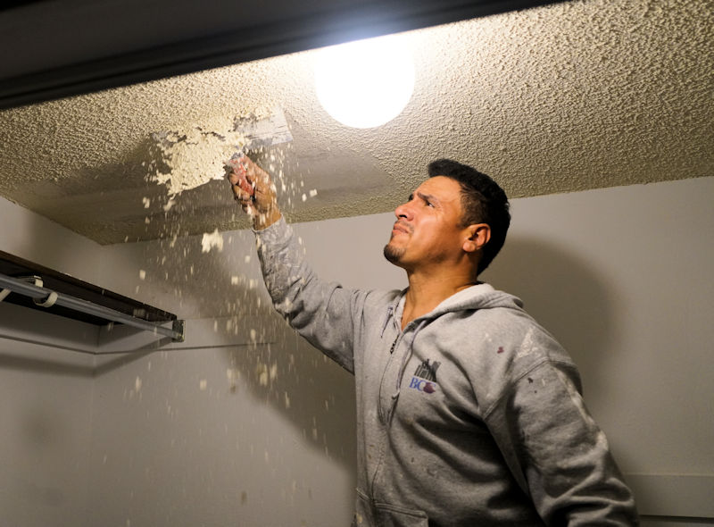 scraping off the popcorn from a ceiling